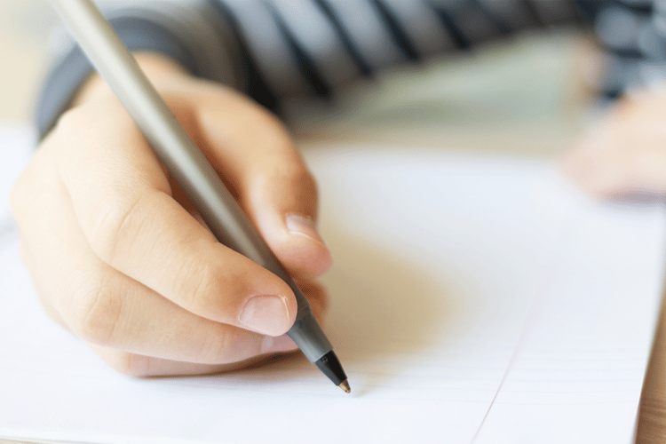 kid writing in a notebook